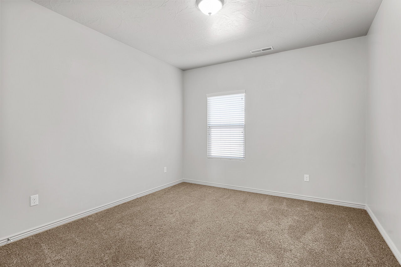 Unfurnished room featuring carpet floors and a textured ceiling