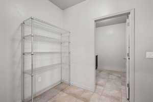 Bathroom featuring baseboards and light tile patterned flooring