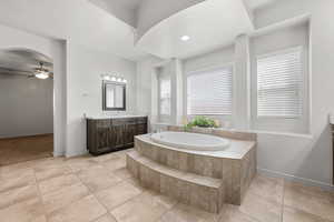 Full bath with vanity, a garden tub, a ceiling fan, recessed lighting, and light tile patterned flooring