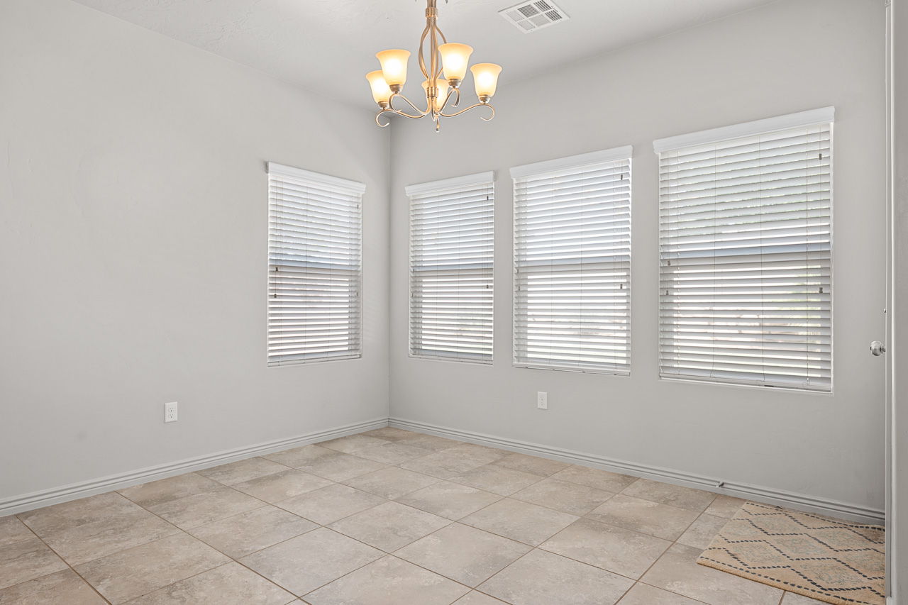 Spare room featuring a chandelier and light tile patterned floors