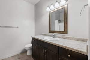 Bathroom featuring vanity, light tile patterned flooring, and a shower with shower curtain
