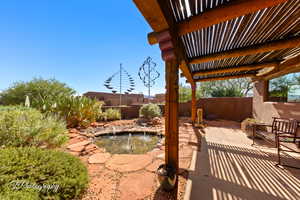 Yard, garden pond, and a patio area
