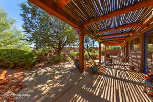 Fenced backyard featuring a patio area, a pergola, and outdoor dining space