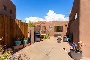 View of patio with a grill