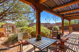 Fenced backyard featuring outdoor dining space, a pergola, a patio, and a gate