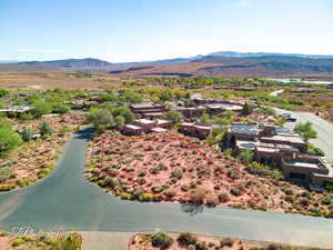 Aerial view of residential area featuring a mountainous background and property parcel outlined