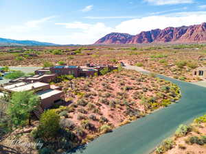 Aerial view of sparsely populated area featuring a desert landscape and a water and mountain view