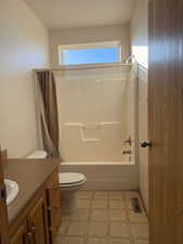 Bathroom with shower / bath combo and vanity