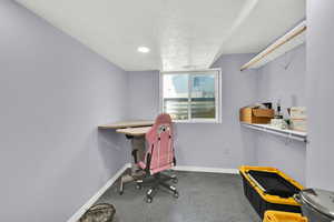 Office area with a textured ceiling and recessed lighting