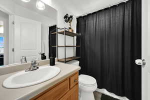 Full bathroom with vanity and curtained shower