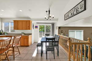 Dining area featuring a textured ceiling, plenty of natural light, light tile patterned floors, a chandelier, and recessed lighting
