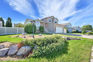 View of front of home featuring driveway, stucco siding, and a garage