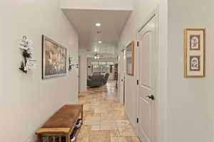 Corridor featuring recessed lighting and stone tile floors