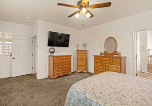 Bedroom featuring a ceiling fan and light colored carpet