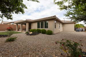 Back of property with a patio, stucco siding, and a tile roof