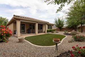 Back of house with a patio, a fenced backyard, stucco siding, and a tile roof