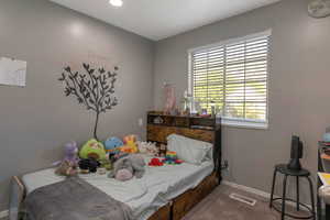 Bedroom with carpet floors and recessed lighting