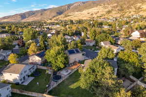 Aerial view of property's location with nearby suburban area and a mountain backdrop
