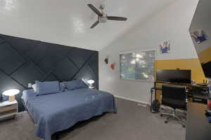 Bedroom with a desk, lofted ceiling, a ceiling fan, and carpet floors