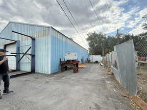 View of vehicle parking with an outbuilding