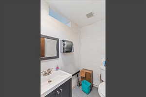 Bathroom with vanity and concrete block wall