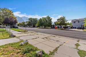 View of asphalt road featuring sidewalks
