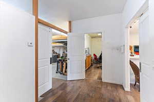 Hallway featuring an office area and dark wood finished floors