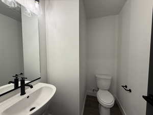 Bathroom with a sink and dark wood-style flooring