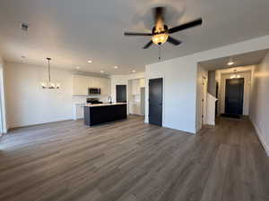 Kitchen featuring a chandelier, open floor plan, pendant lighting, light countertops, and recessed lighting