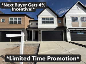 View of front of property featuring brick siding, driveway, an attached garage, a porch, and a standing seam roof