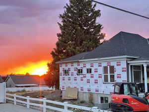 View of property exterior with a shingled roof