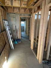 Miscellaneous room with unfinished concrete floors