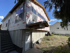 View of side of property featuring stairs