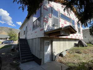 View of home's exterior with a mountain view and stairs