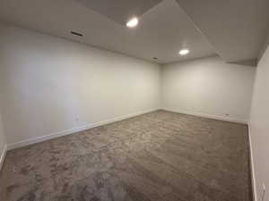 Finished basement with carpet and recessed lighting