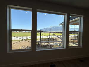 Detailed view of a mountainous background, wood finished floors, and a view of rural / pastoral area
