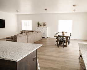 Living area with light wood-style flooring and baseboards