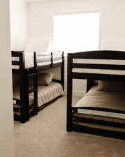 Bedroom featuring light colored carpet