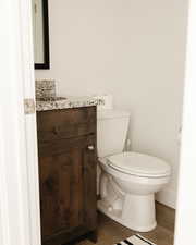 Half bath with vanity and light wood-type flooring