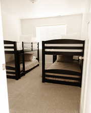 Bedroom featuring light carpet