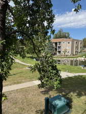 View of community with a lawn and a water view