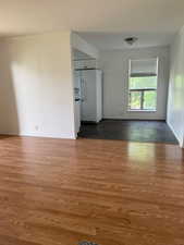 Unfurnished room featuring crown molding and wood finished floors