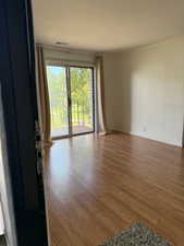 Empty room with wood finished floors and ornamental molding