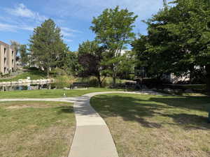 View of community with a yard and a water view