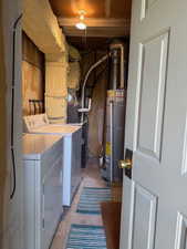 Laundry room with water heater and washing machine and dryer