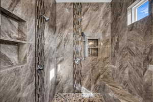 Bathroom featuring tiled shower