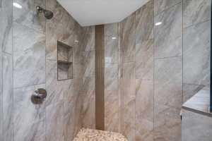 Bathroom featuring a tile shower