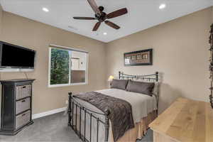 Carpeted bedroom with recessed lighting and a ceiling fan