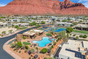 Aerial view of residential area with a mountainous background and a pool area