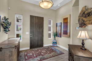 Foyer entrance featuring wood finished floors and recessed lighting